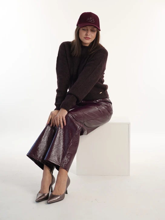 An autumn outfit in shades of burgundy, plum, and metallic